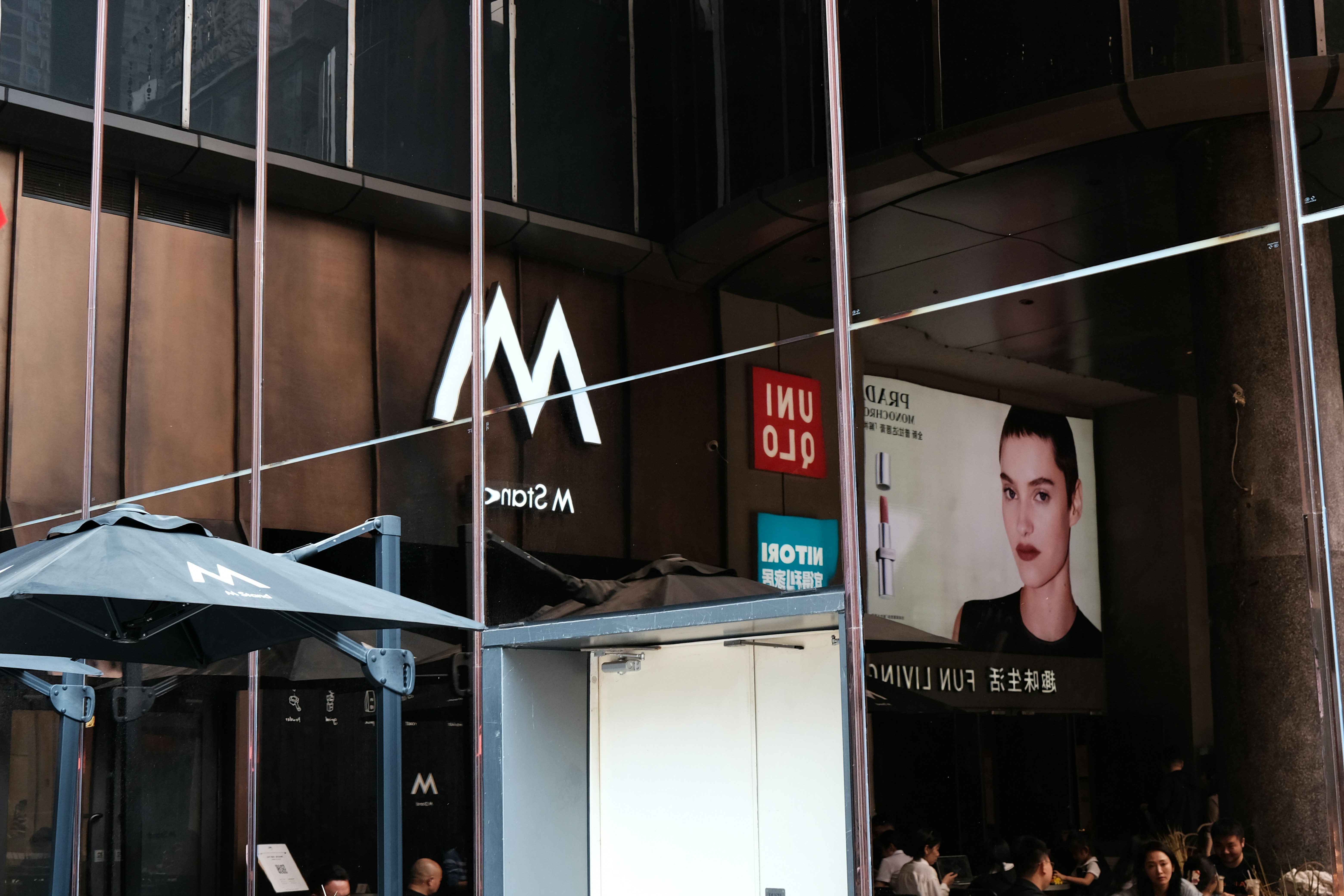 a group of people sitting outside of a building